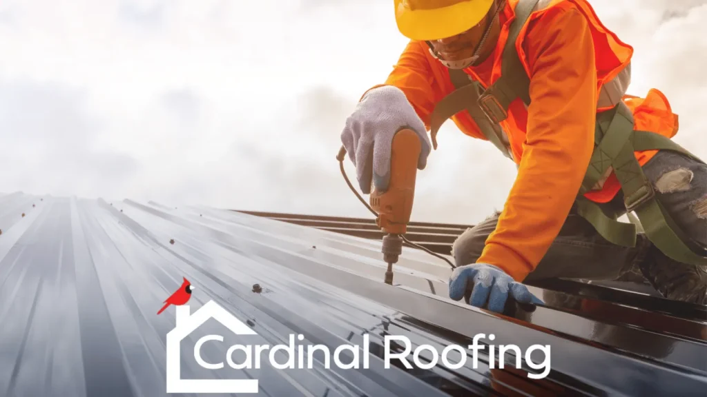 Cardinal Roofing poster of worker drilling metal roof piece